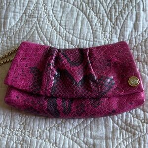 Henri Bendel fuchia and black snakeskin patterned wristlet